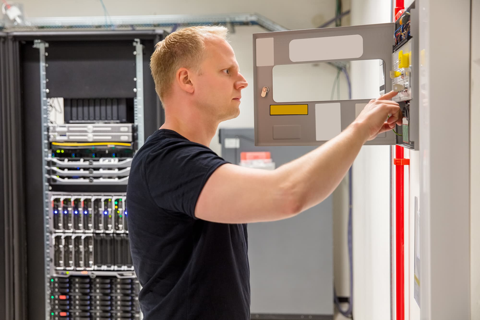 man inspecting electrical panel